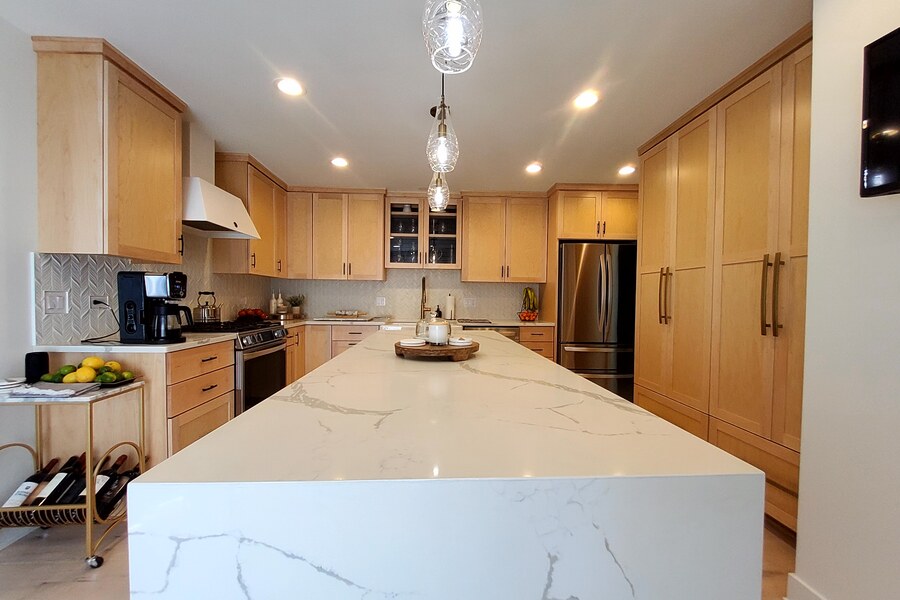 After: maple kitchen with Calacatta quartz waterfall island